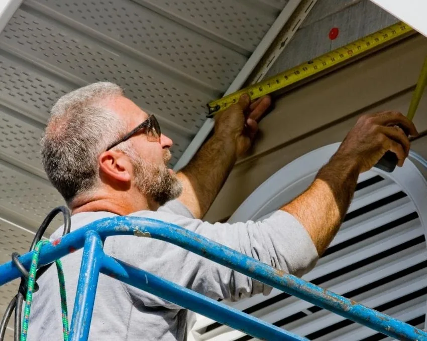 Worker assessing an existing exterior